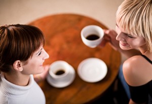 Two young women enjoying a coffee break